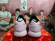 Rear view of pink and white Nike basketball sneakers showing padded collars, heel branding, layered midsoles, and black outsoles.