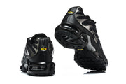 Rear and outsole views of black sneakers with sculpted soles