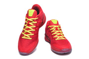 Pair of red low-top basketball shoes with yellow laces and bright tongue accents, viewed from the front.
