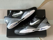 Angled view of the sneaker pair on a black shoebox, showing the Swoosh, midsoles and outsole details.