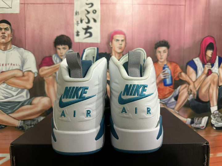 Rear view of white and blue high-top sneakers showing heel logos and contrasting accents