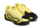 Three-quarter view of the yellow and black sneakers showing the black toe panels, side detailing, and lace-up construction.
