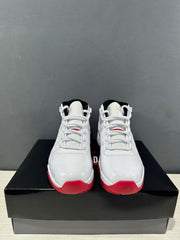 Front view of the paired sneakers showing white laces, black collar lining, and red toe accents.