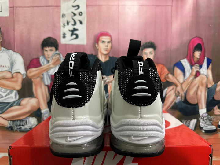 Rear view of white and black Nike sneakers showing heel details and pull tabs