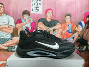 Side view of a black Nike basketball sneaker with a silver Swoosh and sculpted silver midsole accent.