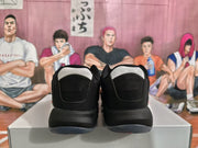 Rear view of the pair showing black heel panels, white collar accents, and dark midsoles.