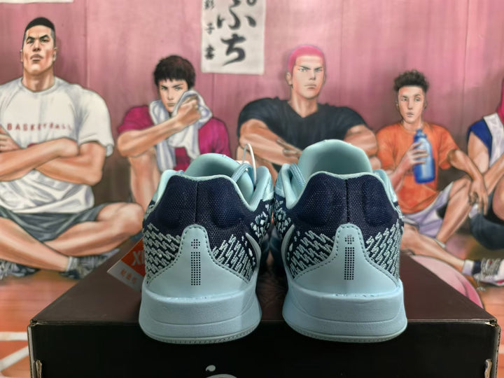 Rear view of blue and black Nike Kobe basketball shoes with patterned side panels