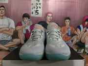 Front view of the gray Nike basketball sneakers showing the laces, padded tongues, and rounded toe boxes.