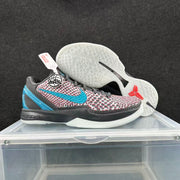 Side and outsole view of Nike basketball sneakers showing the patterned upper, blue accent, dark midsole and translucent outsole.