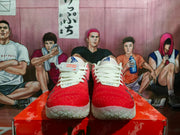 Front view of the pair showing red toe sections, white laces, pink side areas and light-colored outsoles.