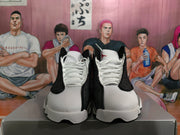 Front view of black, grey, and white high-top basketball sneakers with white laces and visible tongue branding.