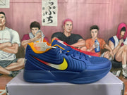Side view of a blue Nike basketball sneaker showing a yellow swoosh, red accent stripe, padded upper, and basketball-style sole.