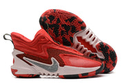 Red Nike Anthony Edwards 2 basketball shoes with black and pale accents.