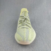 Top-front view showing the patterned laces, knit toe box, and rounded sneaker shape.