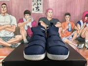 Front view of navy blue high-top basketball sneakers with layered hook-and-loop straps and light-colored outsoles.