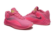 Pair of pink Nike Giannis Immortality 7 basketball shoes from an angled view