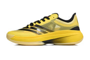 Side profile of a yellow basketball shoe with black stripes and lace-up fastening