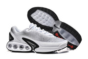 White and black Nike Air Max DN sneakers shown from the side and outsole.