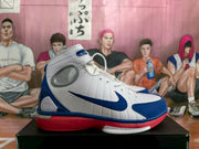 Side profile of a white Nike high-top sneaker with blue Swoosh branding and red outsole accents.