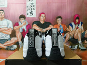 Rear view of white and black Jordan sneakers showing heel tabs and molded heel details