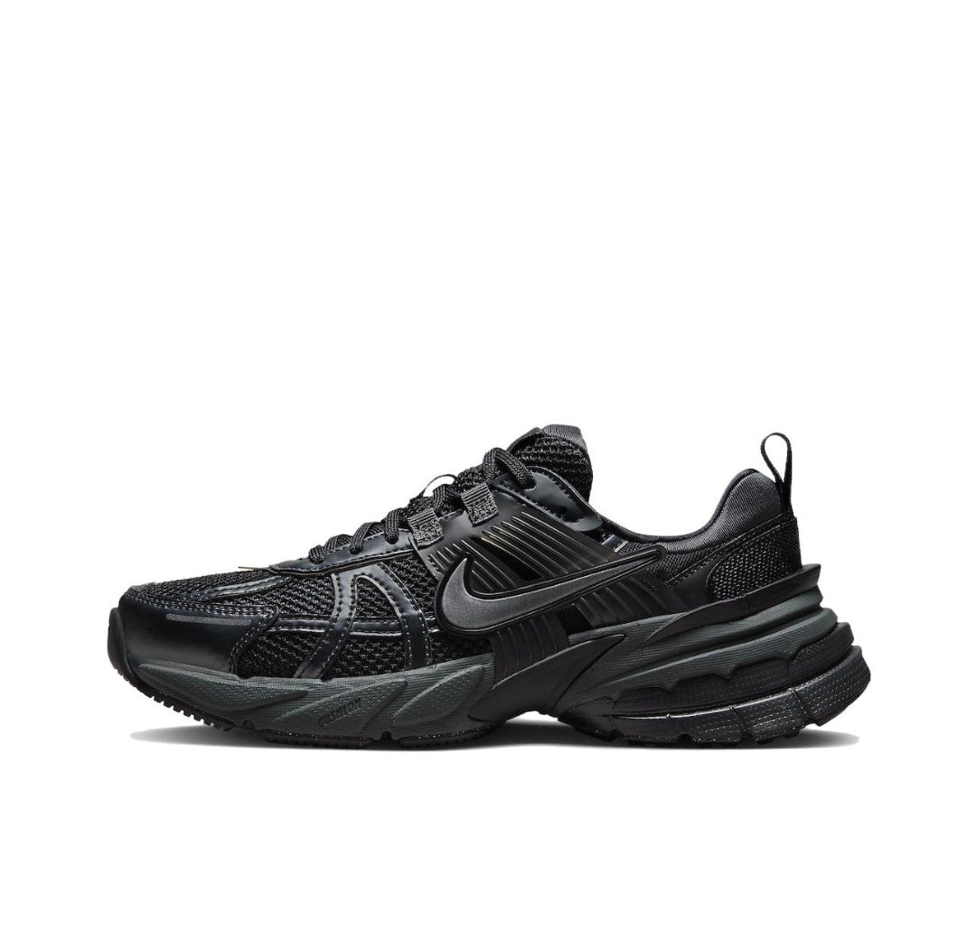 Side view of a black Nike lace-up sneaker with layered side detailing and a chunky sculpted sole.