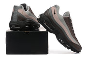 Nike Air Max 95 sneakers displayed beside a black shoebox