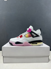 Side profile of the white Jordan Air Jordan 4 Retro sneaker with black supports and pink outsole details.