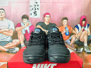 Front view of black Nike sneakers with lace-up uppers and sculpted toes.