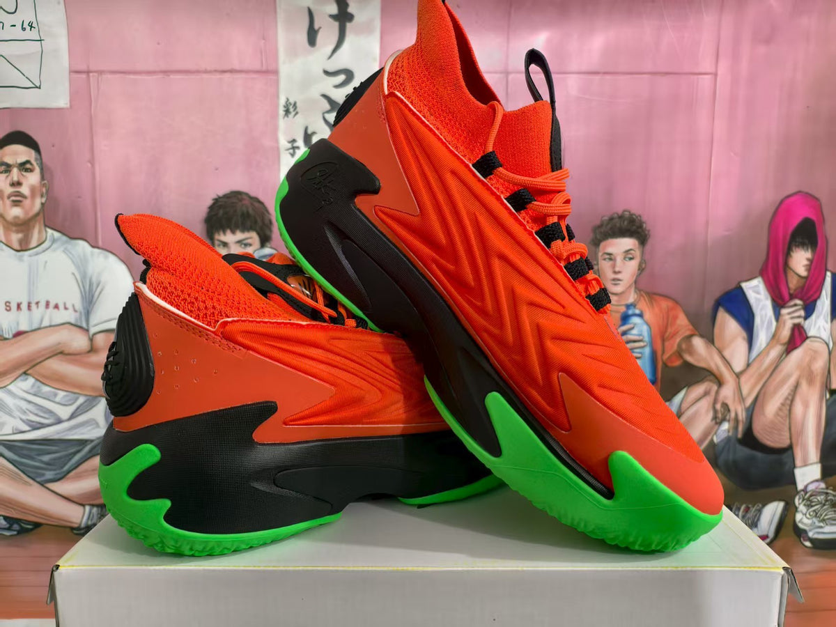 Pair of orange, black, and bright green basketball sneakers shown from a side and three-quarter angle.