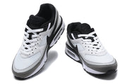 Pair of white, black, and grey Nike Air Max sneakers shown from the front.