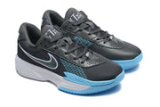 Angled view of the pair of dark grey Nike basketball shoes with light blue accents.