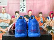 Rear view of blue Nike Kobe basketball shoes showing signature heel details.