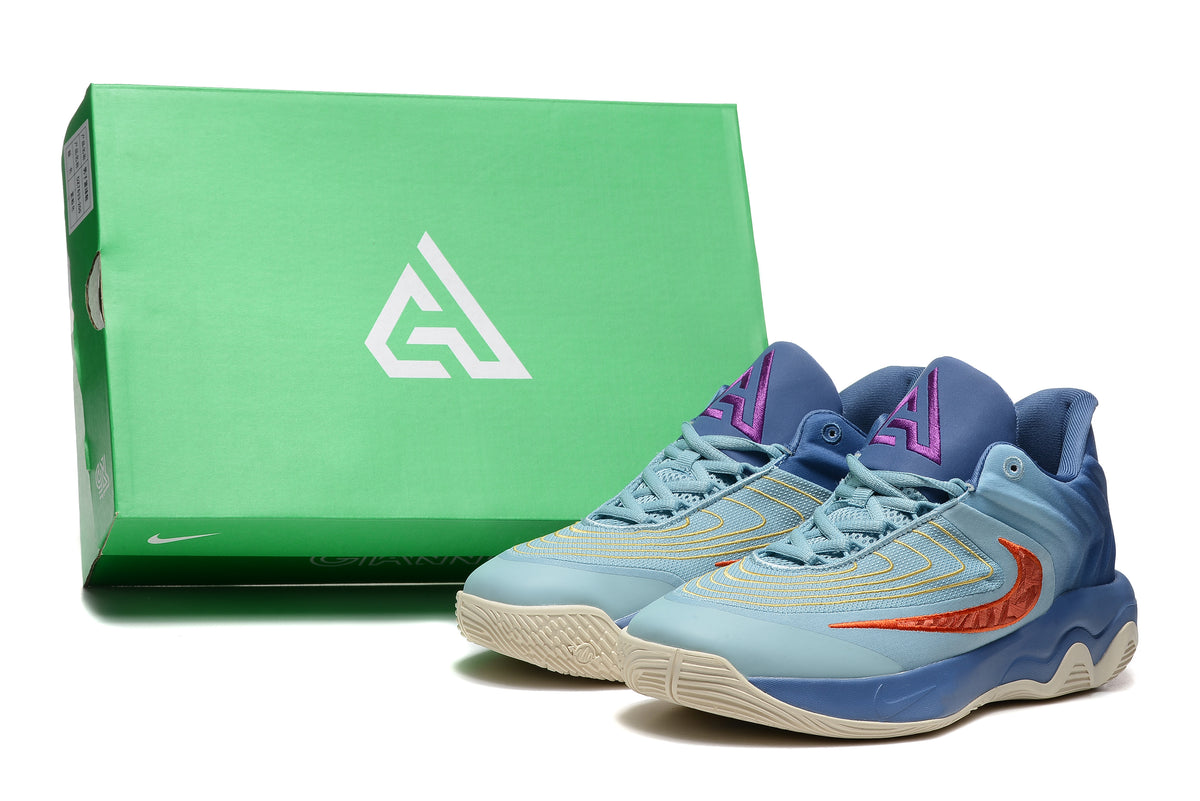 Pair of blue Nike basketball shoes with orange-red accents beside a green shoe box