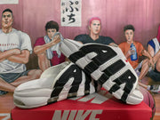 Angled side view of the white and black Nike sneakers with AIR lettering, layered panels and cushioning units.