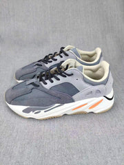 Pair of grey lifestyle sneakers shown from an angled front-side view.
