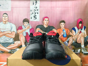 Pair of black and red basketball shoes shown from the front