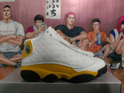 Side profile showing the white dimpled panel, yellow overlay, and black outsole