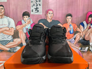 Front view of black and grey Nike basketball sneakers showing laces, padded tongues, patterned toe panels and textured outsoles.