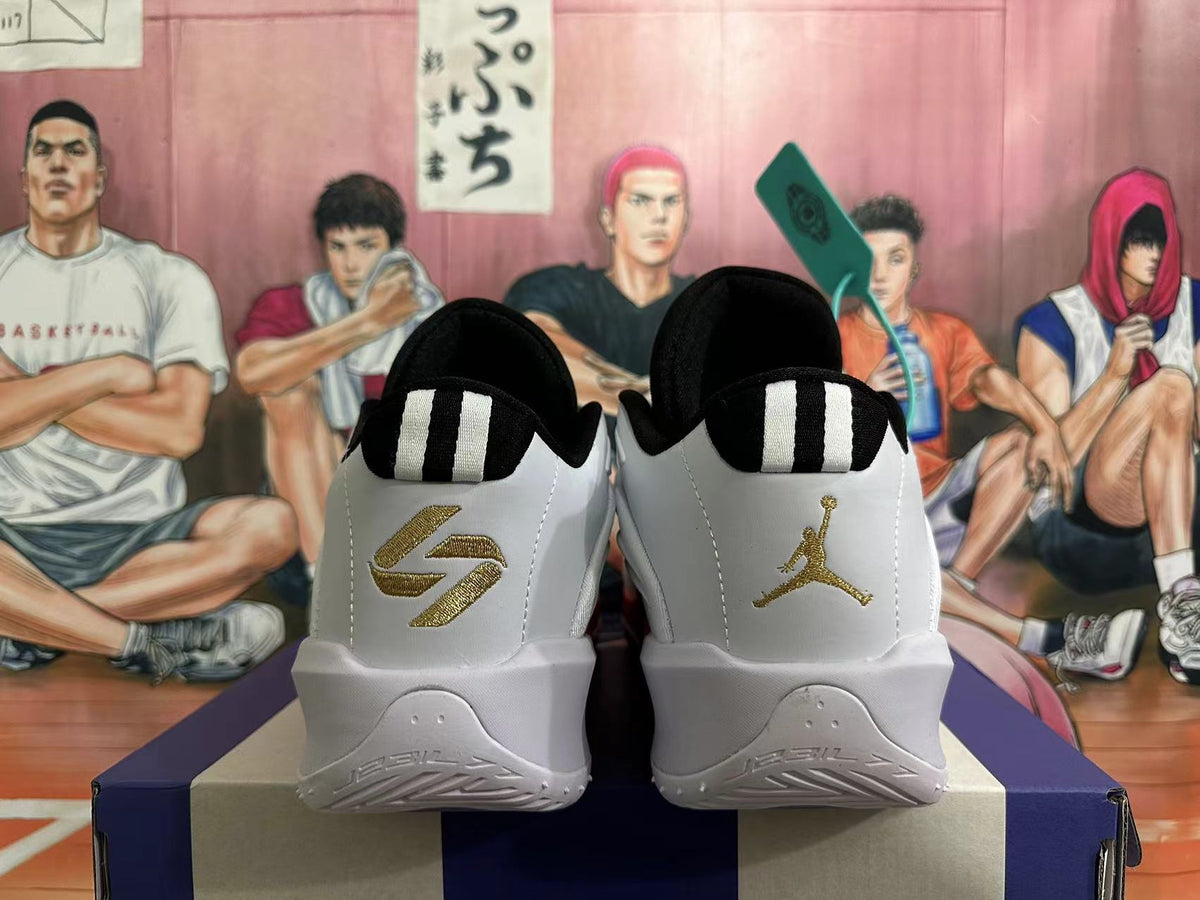 Rear view of white and grey basketball shoes with black heel tabs and gold branding