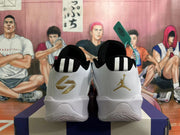 Rear view of white and grey basketball shoes with black heel tabs and gold branding