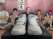 Front view of the white basketball shoes with blue accents and KD tongue logos.