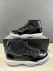 Angled side view of two black high-top sneakers with blue branding and white midsoles.