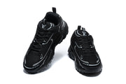 Pair of black graphic sneakers shown from the front.