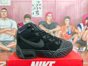 Side view of a black Nike high-top basketball-style sneaker with layered panels, lace-up closure, purple accent, and textured outsole.