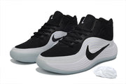 Pair of black and white Nike basketball sneakers with pale translucent-looking outsoles and spare white laces.