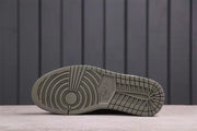 Underside view showing the circular and grid-patterned grey rubber outsole.