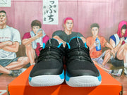 Front view of black Nike basketball shoes with blue accents and white outsoles