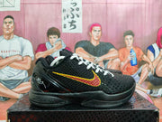 Side view of a black Nike basketball shoe with a red-and-yellow Swoosh