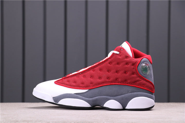 Side view of Air Jordan 13 Red Flint sneakers in red, gray, and white.