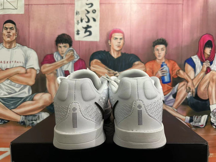 Rear view of white Nike basketball shoes with black heel details